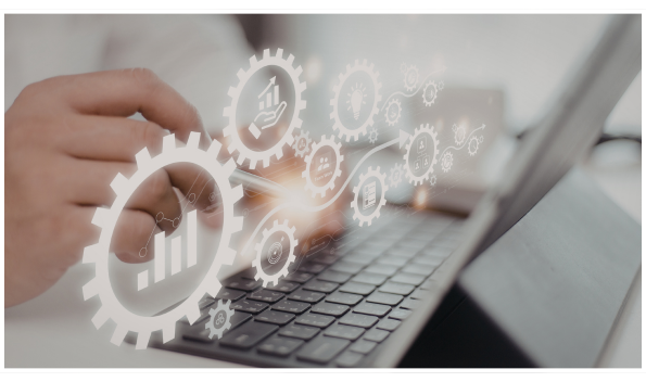 A person uses a tablet with a keyboard, with digital gear icons and business-related gears, graphs, and charts overlaying the image, representing modular automation.