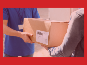 warehouse employee handing a right-sized cardboard package to another employee