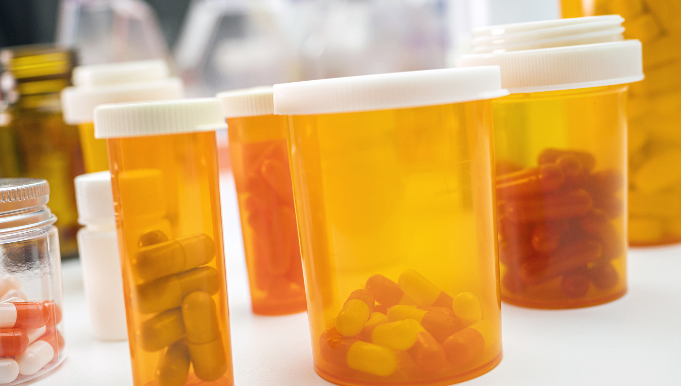 Several amber transparent prescription pill containers